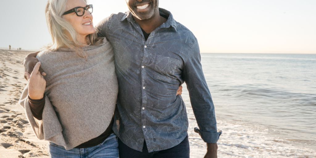 mature couple walking together on the beach