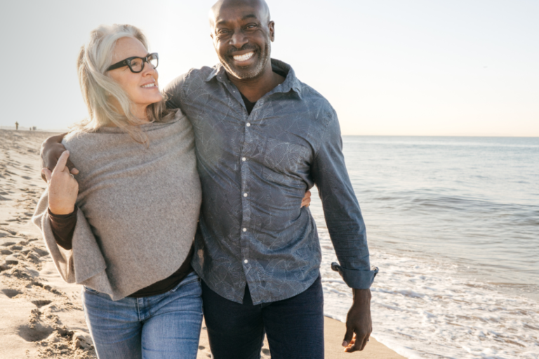 mature couple walking together on the beach
