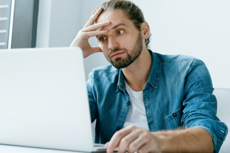 Man looking frustrated on his computer