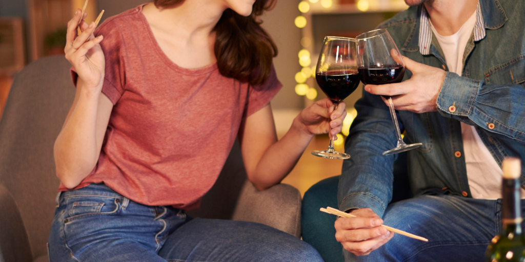 couple eating sushi and drinking red wine
