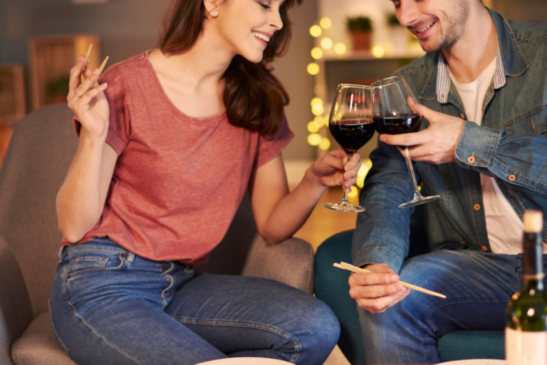 couple eating sushi and drinking red wine