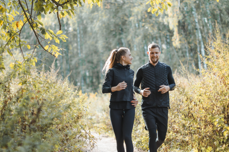 couple jogging in the woods