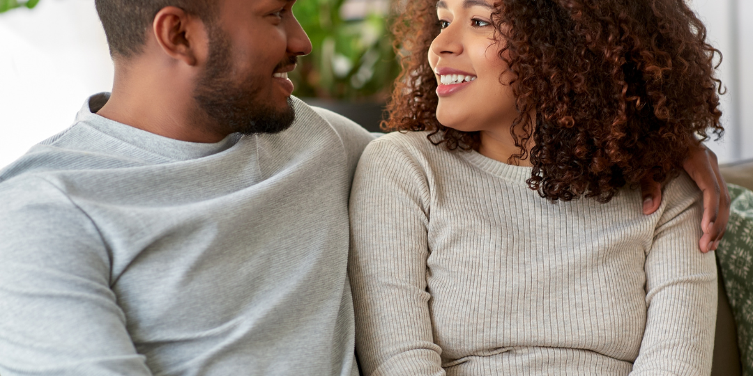 couple staring at each other on the couch