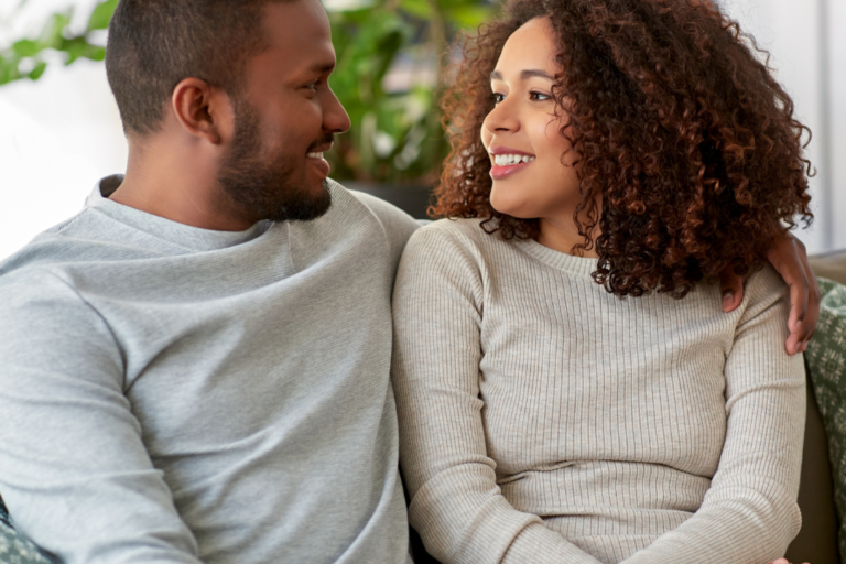 couple staring at each other on the couch