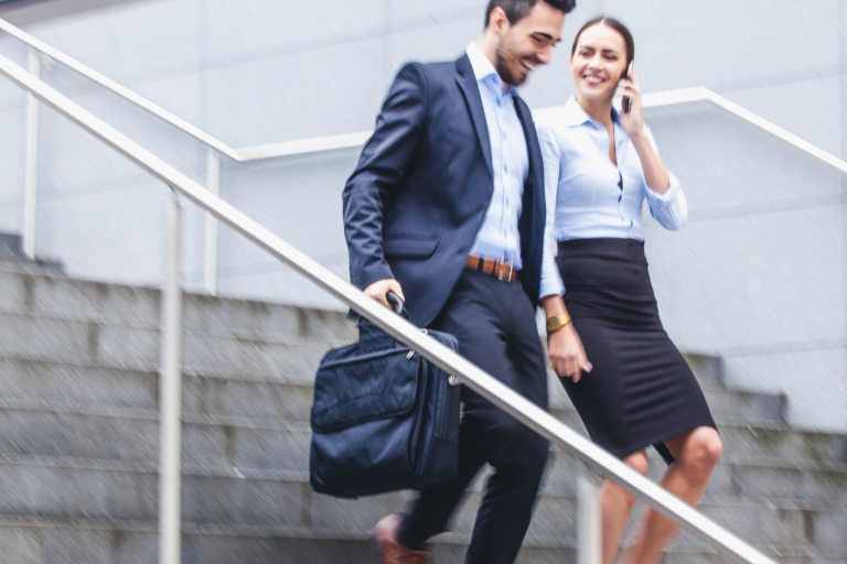 business minded couple walking down steps together
