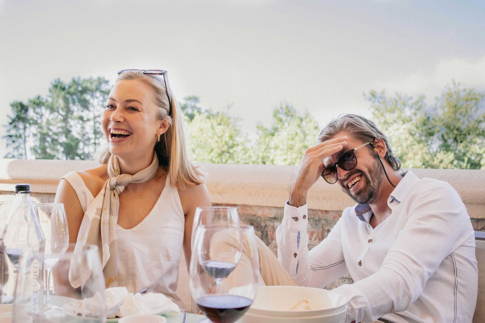 Couple laughing together over a relaxed lunch