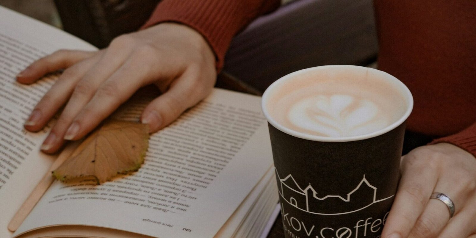 reader-mailbag-woman-reading-coffee A woman reading with a cup of coffee, cozy and unhurried.