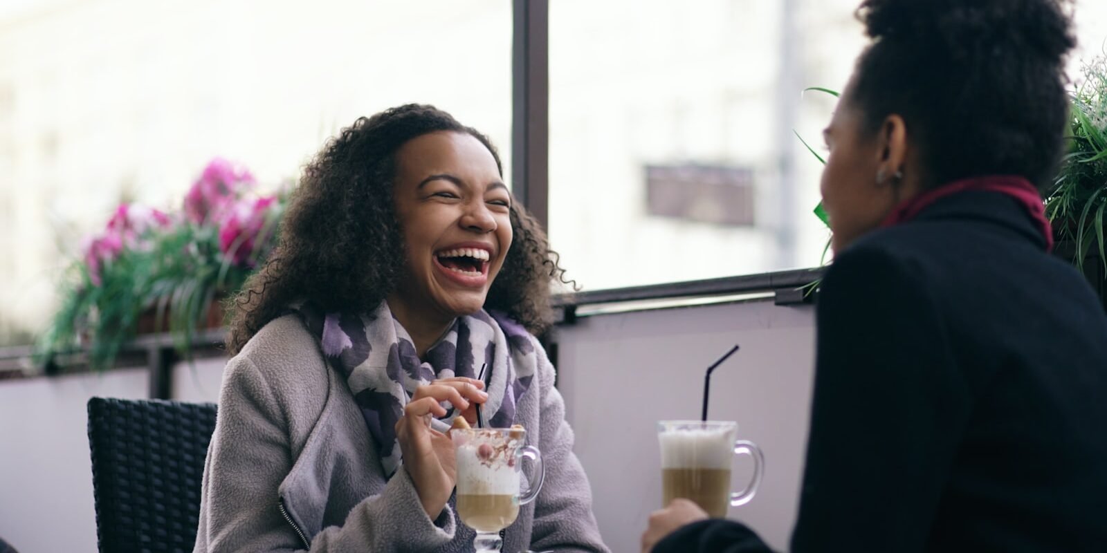 The One Thing Your Dating Checklist Cant Measure Two people talking and laughing together over coffee.